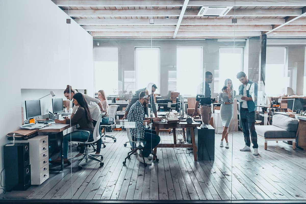 Group of young business people in smart casual wear working together in creative office.